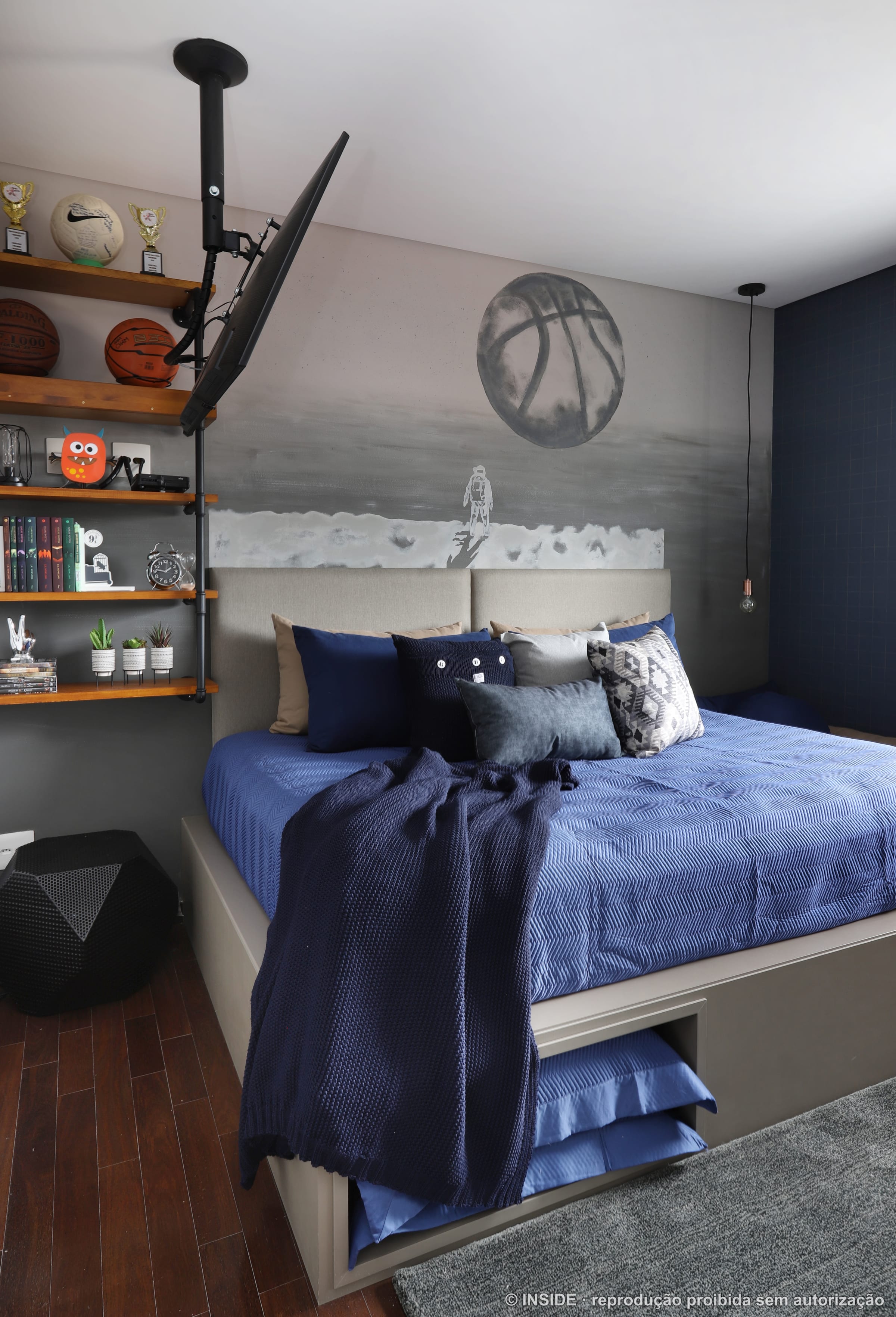 Quarto de menino com roupa de cama azul, tema basquete, prateleiras industriais e cadeira ovo laranja, projeto INSIDE